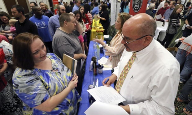 Jobhunters discuss their CVs with representatives of Chattanooga Labeling Systems at a job fair in Georgia. Although the headline jobs figure disappointed analysts, long-term joblessness fell and the unemployment rate remained at 5.5%.
