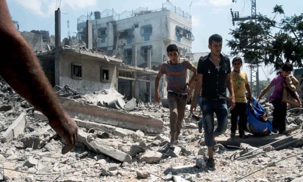 A group of Palestinian children and teenagers rescue possessions from a devastated area of northern Gaza during a ceasefire in last summer's summer's war.