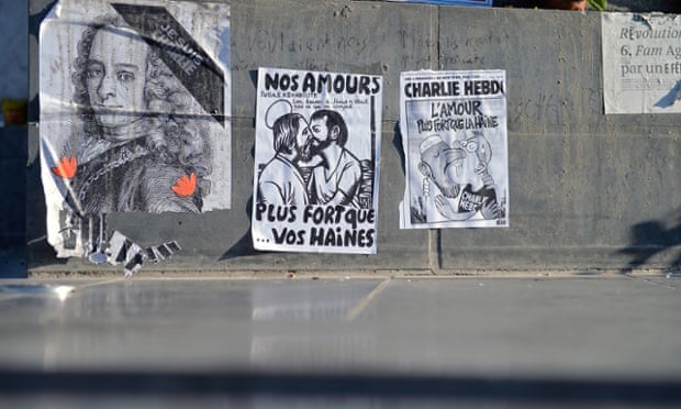 Poster of Voltaire (left) left by the public near Charlie Hebdo's offices in Paris a month on from the terrorist attacks which left 12 dead in February.