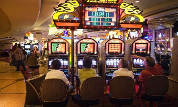 Gamblers trying their luck on the Hot Shot slot machines, Harrah's Casino, Las Vegas.  'Lukewarmers' have also been described as 'Luckwarmers' because they want to gamble our future on the best case scenario.