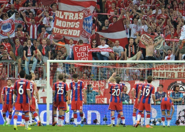 The dejected Bayern players applaud their supporters at the end of the match.