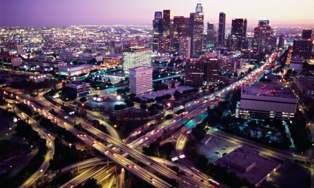 The freeway interchange of the Harbor Freeway (California Highway 110) and the Hollywood Freeway (US 101) just north of Downtown Los Angeles, at dusk.
