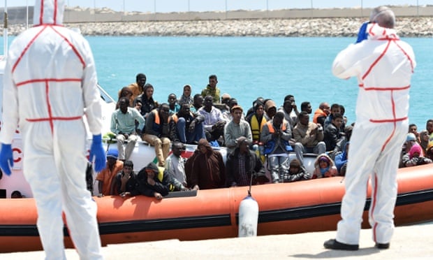 An Italian coastguard ship carrying migrants arrives at Pozzallo's harbor near Ragusa, Sicily on 19 May.