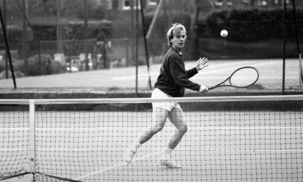 Author Martin Amis making a backhand return as he plays tennis.