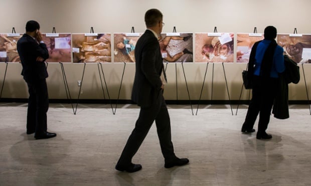 Visitors look at the controversial photographs of dead bodies at the United Nations Headquarters in New York.