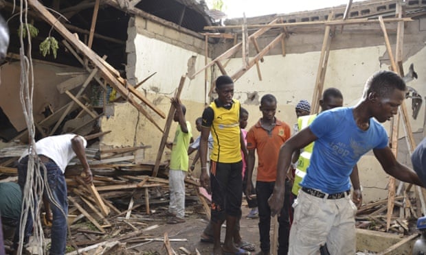 Rescue workers gather at the site of an explosion in Maiduguri, Nigeria, on Saturday