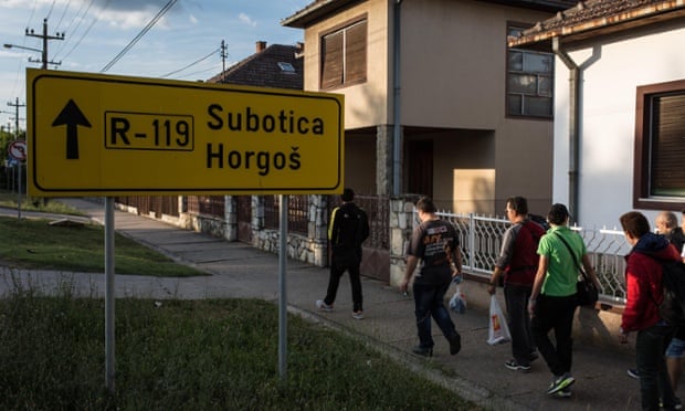 Migrants walk through Kanjiza, Serbia, northwards to Hungary.