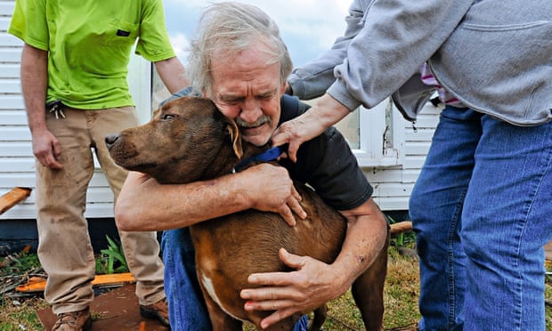Greg Cook, 59, hugs his dog Coco after a tornado destroys his home in Alabama, 2012 Greg Cook, 59, hugs his dog Coco after a tornado destroys his home in Alabama, 2012