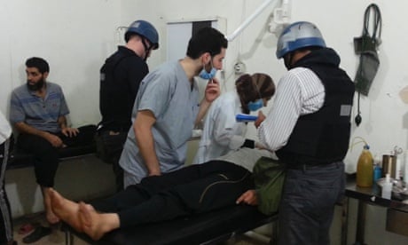 U.N. chemical weapons experts visit people affected by an apparent gas attack, at a hospital in the southwestern Damascus suburb of Mouadamiya.