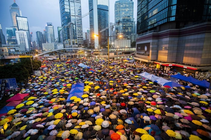 Pro-democracy protesters in Hong Kong open their umbrellas for 87 seconds, marking the 87 rounds of teargas fired by police at unarmed student protesters in the same location one month ago. The Admiralty district protest zone has been dubbed Umbrella Square.