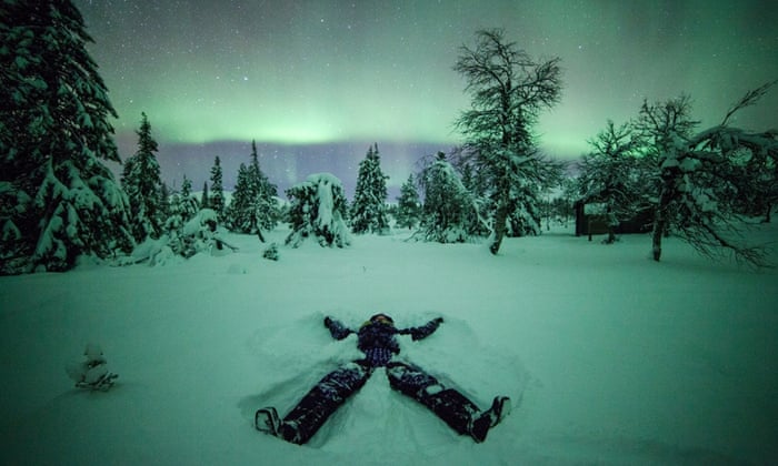 Creating a "snow angel" (made by lying in the snow and waving your arms and legs)  takes on an particularly magical quality with the Northern Lights glowing on the horizon.