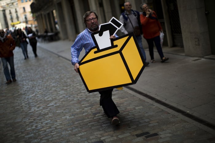 Girona, Spain Businessman Emilio Busquets carries a drawing of a ballot box to decorate his shop before a symbolic vote on independence of Catalonia from Spain