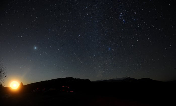 The Geminid meteor shower is seen while the moon rises late above Skopje, Macedonia. There are three major meteor showers during a year and this weekend's Geminid is the one visible in both hemispheres.