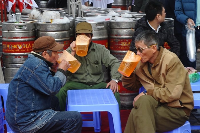 Hanoi, Vietnam Men drink beer at an annual beer festival, where they could enjoy the popular cheap draft beer Bia Hoi for free