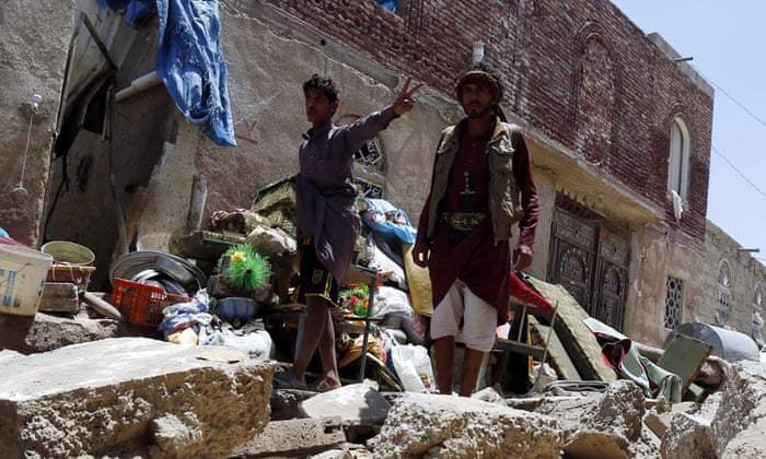 Yemenis collect their belongings after their houses were hit by an airstrike in Sana'a. Many are fleeing to neighbouring countries, threatening to overload refugee camps.