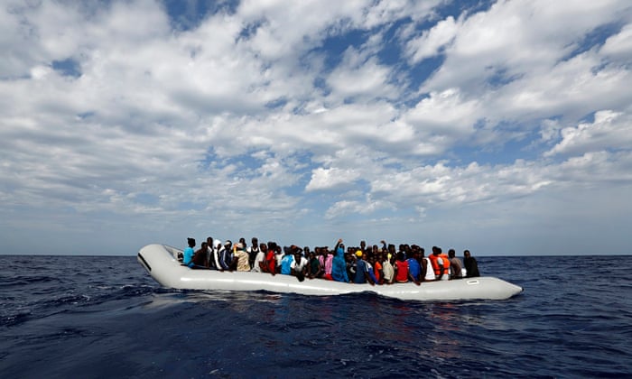 A dinghy packed with migrants off the Libyan coast
