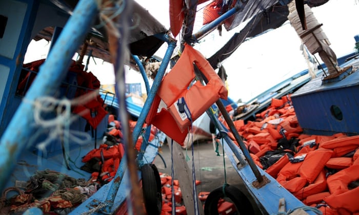 Life jackets used by migrants are seen left on two flotsams at the Sicilian harbor of Pozzallo, February 16, 2015. Better weather since last week has encouraged migrants to make the perilous journey from North Africa, where a breakdown of order in Libya has made it almost impossible to police the traffickers who pack people onto rickety boats.