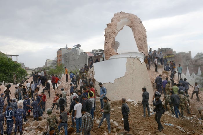 Nepalese rescue workers gather at the collapsed Darahara Tower in Kathmandu