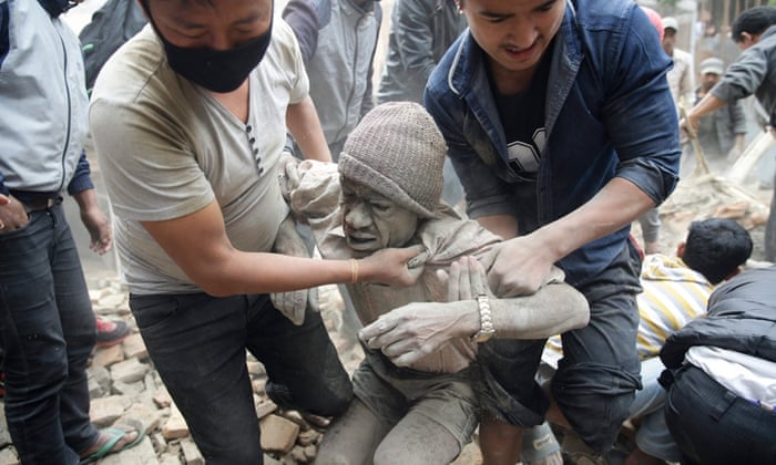 People free a man from the rubble of a destroyed building