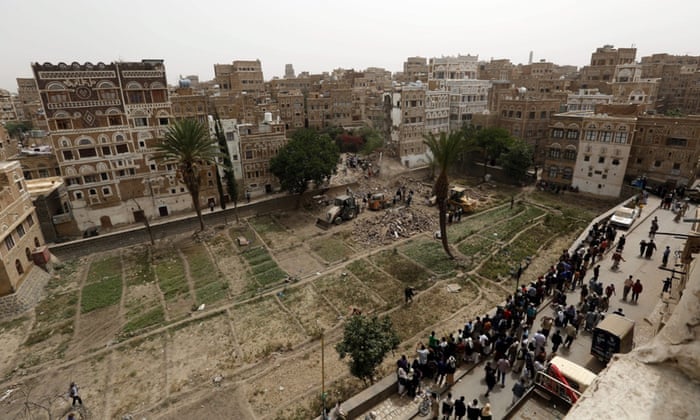 Yemenis inspect old buildings reportedly destroyed by an air strike carried out by the Saudi-led coalition