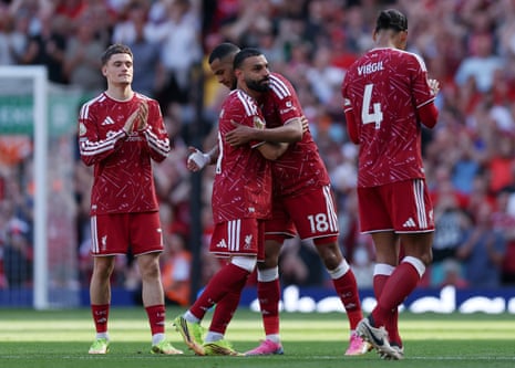 Mo Salah of Liverpool embraces teammate Cody Gakpo as he is substituted off