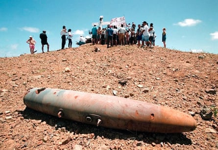 group of people in background, with metal cone on ground in foreground