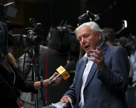 Attenborough talking to a person holding a microphone