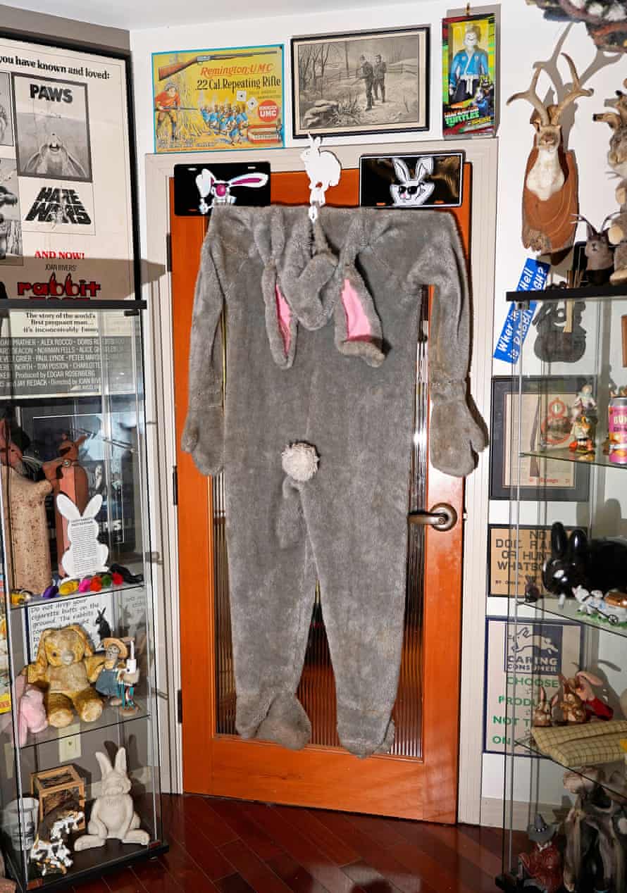 bunny suit hangs on a door among other memorabilia