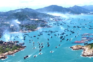 Aerial view of dozens of boats leaving port