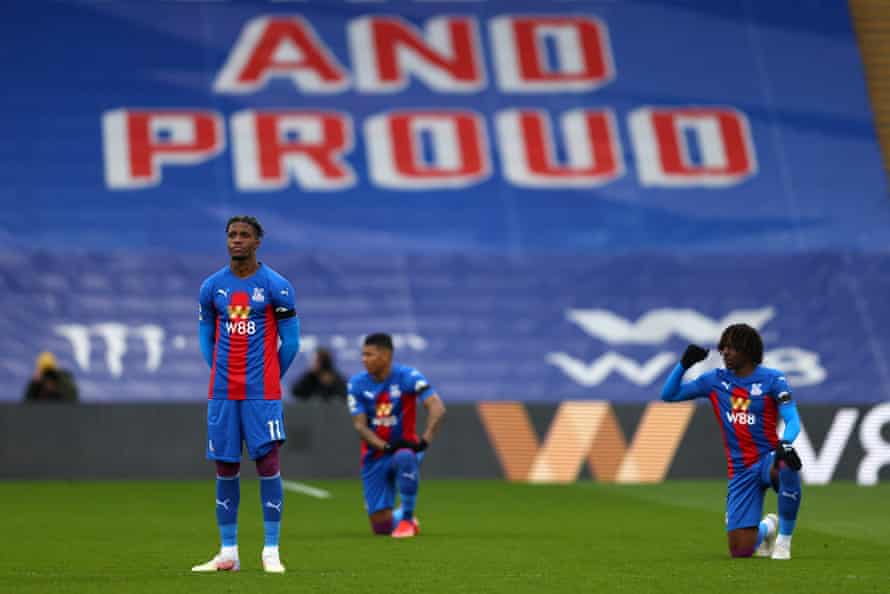 In objection to the ongoing threat of racism in society, Wilfried Zaha of Crystal Palace opts to stand while his team-mates Patrick van Aanholt and Eberechi Eze take a knee before kick-off against Chelsea.