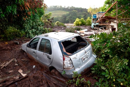 The wreckage of a car and a house are seen a day after the collapse of a dam at a mine belonging to Brazil’s giant mining company Vale.