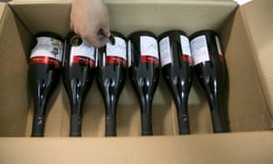 A worker places stickers on wine bottle