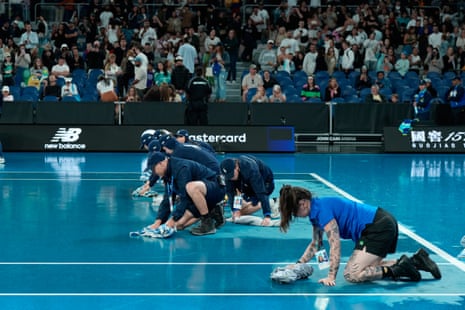 groundstaff clear rain from the court