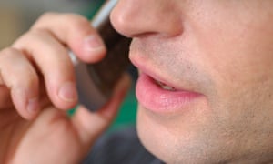 close up of mouth of man with cellphone