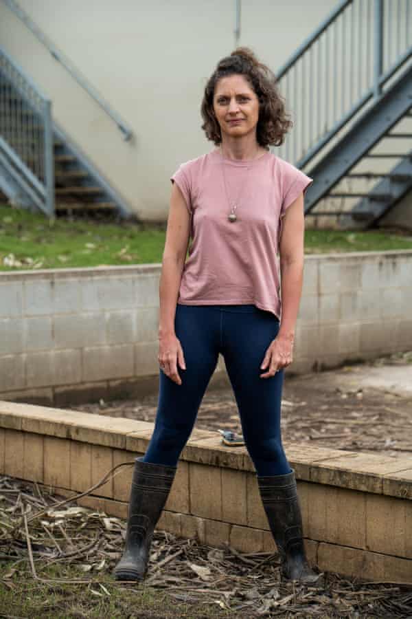 Bungawalbin resident Kate Coxall stands looking at the camera, she is wearing a pink T-shirt, blue pants and black gumboots