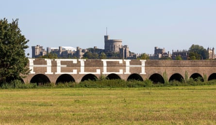 The tag HELCH sprayed in white on a railway viaduct. Windsor Castle is behind it.