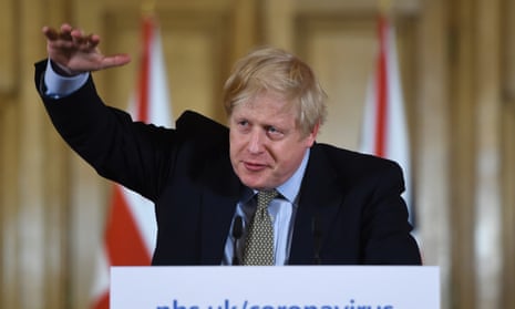 Boris Johnson gestures during a news conference regarding the coronavirus, in Downing Street.