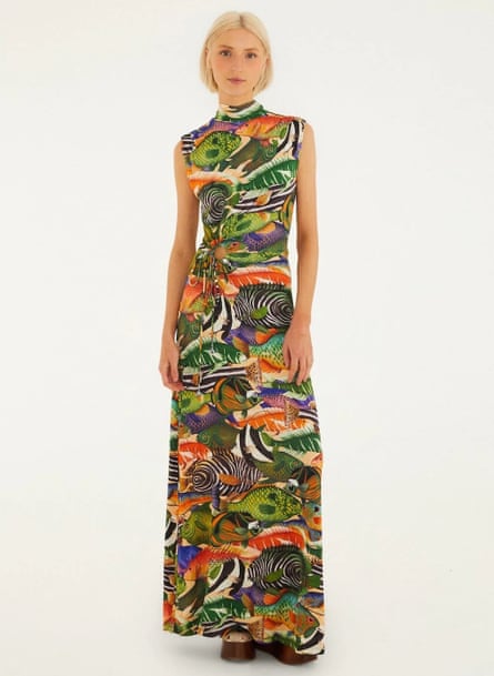 A female model wears a maxi dress with a colourful print of various fishes