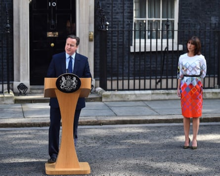David Cameron at a lectern outside No 10 announcing his resignation. Samantha Cameron stands behind.