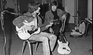 George Harrison and John Lennon. Harrison is playing Lennon’s Framus 12-string Hootenanny acoustic guitar.
