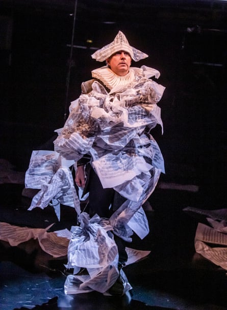 A man is covered in a huge costume of sheet music.