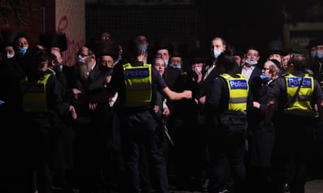 Police control a crowd outside a building near a Ripponlea synagogue in Melbourne on Tuesday