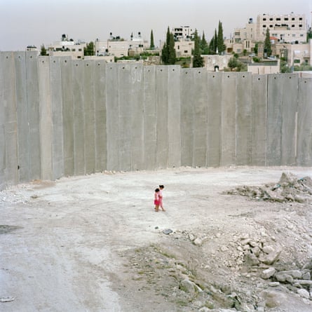 Two children in front of the “Separation Wall” on the West Bank, 2004