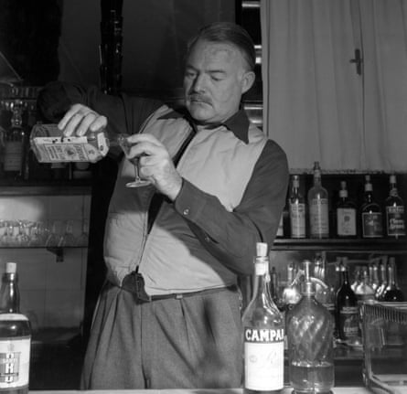 ‘Reminder of normal life’ … Ernest Hemingway pouring himself a gin in 1948.