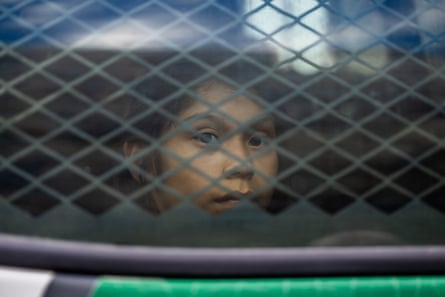 a young girl looking out a window