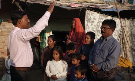 Christian pastor Rajpal Samuel with a first generation Christian family. Hindu groups claim that pastors, are forcibly converting Hindus to Christianity. Pastor Samuel said such charge is baseless. “If people are embracing Christianity they are doing it purely of their own free will.”