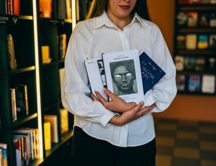 Kateryna Sova shows the very last books that were left for sale after Russian attacks.