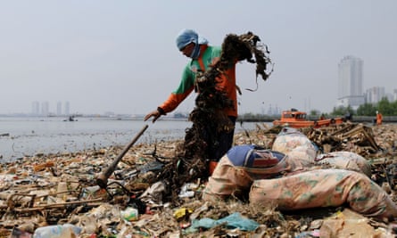 Municipal workers collect rubbish along Jakarta’s shoreline.