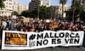 Protesters hold a banner reading 'Mallorca is not for sale'
