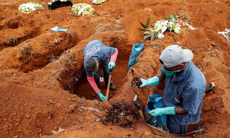 Gravediggers of the Vila Formosa cemetery, the largest in Latin America, exhume old graves to open new spaces for those killed by Covid-19, in Sao Paulo, Brazil, on 15 June 2020.